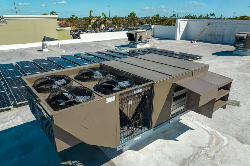 A large commercial rooftop unit with multiple fans on a flat roof.